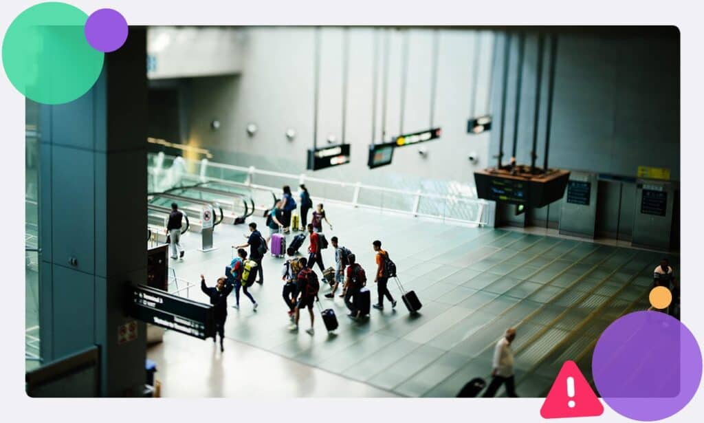 A busy airport terminal with people with suitcases