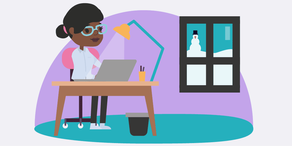 An home worker at their desk and it being cold and wintery outside