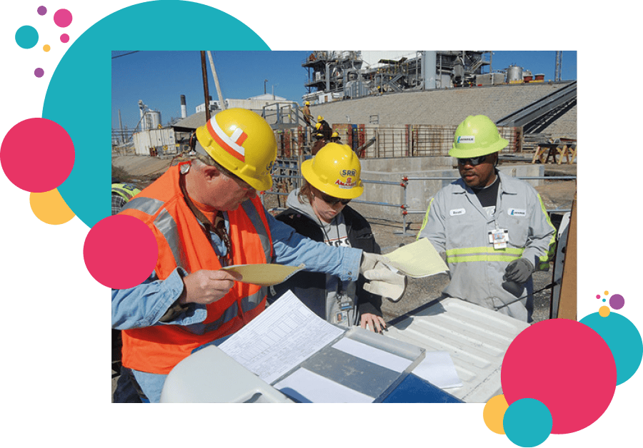 Three construction site workers stressfully reviewing paperwork