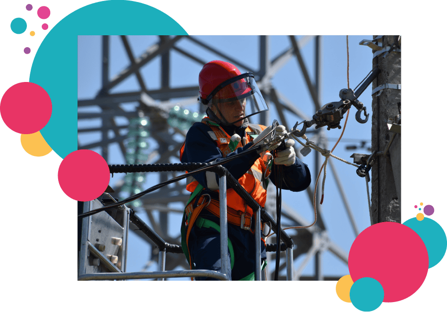 A lone working electrical utilities worker repairing power cables
