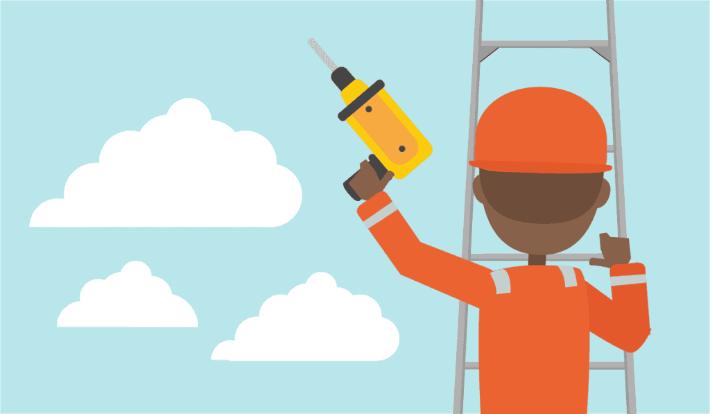 An employee working with a drill whilst up a ladder