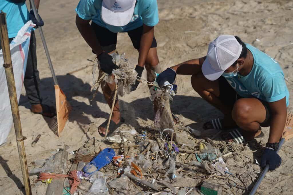 Charity workers cleaning up litter on a beach
