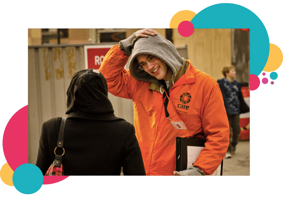 A lone working charity support worker speaking to people on the street
