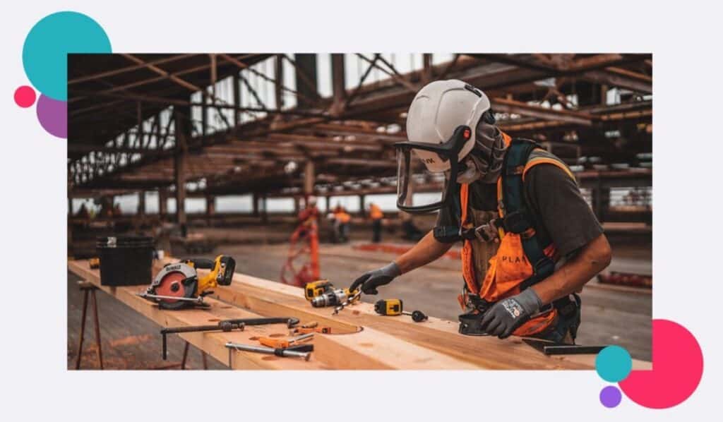 A construction worker alone on a large site with powertools