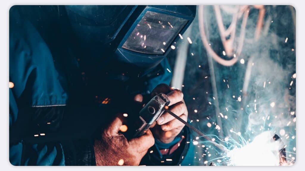 An engineer welding in a mask alone