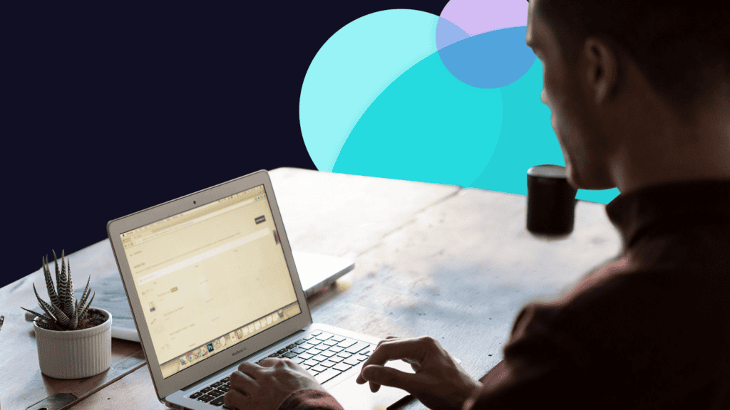 A home based lone worker sitting at a desk with a laptop open