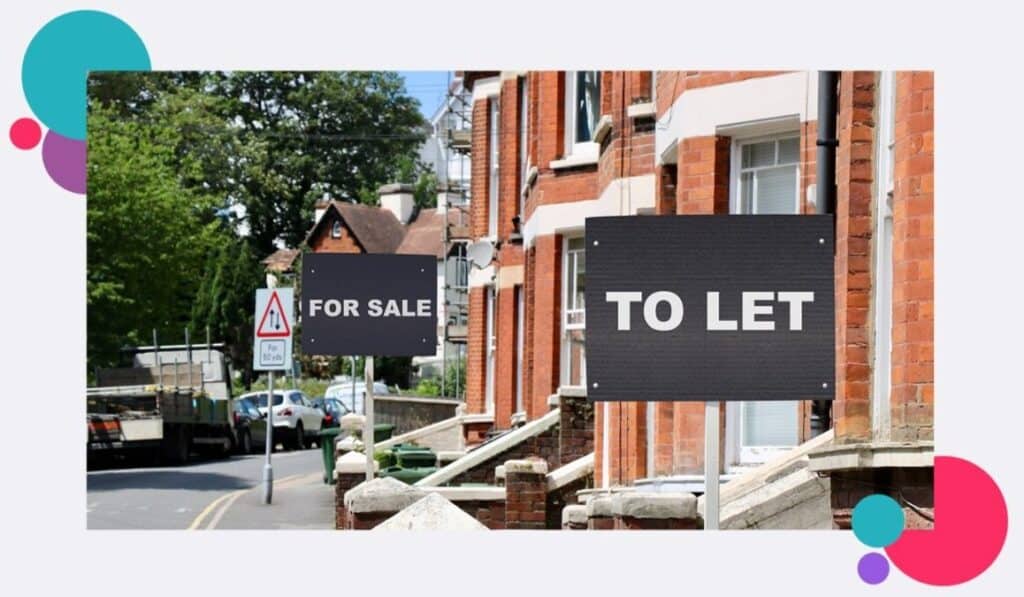 Terraced houses with for sale signs outside