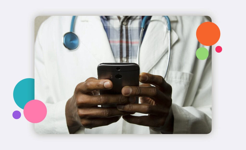 a doctor using a phone with a stethoscope around their neck