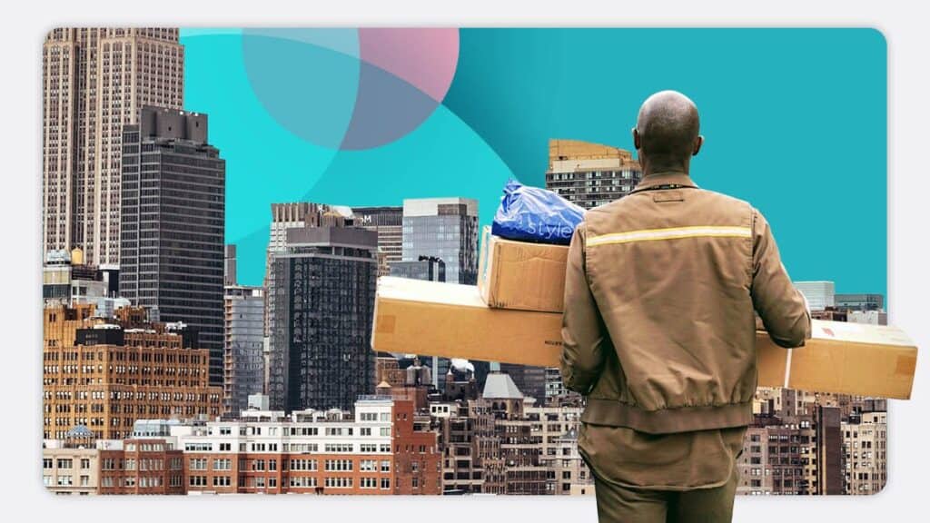 A delivery person with multiple packages overlooking a cityscape