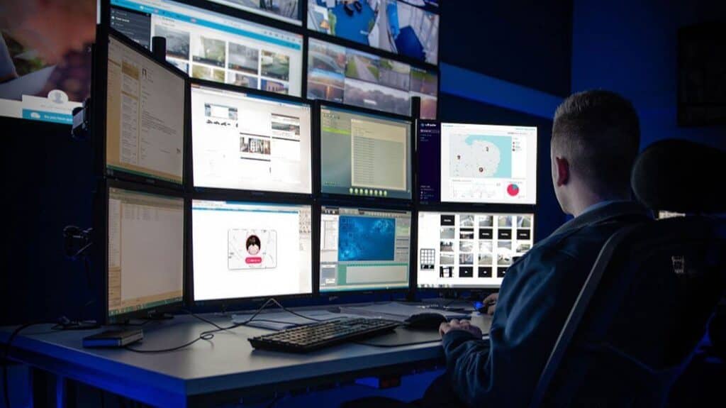 A response centre employee with multiple screens in front of them