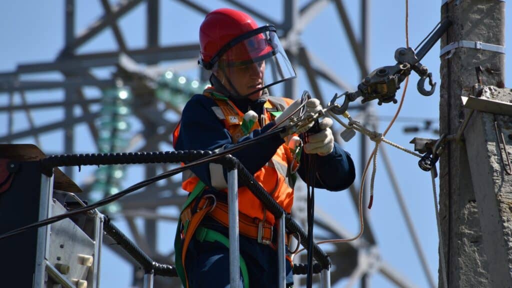 A utilities worker on a powerline