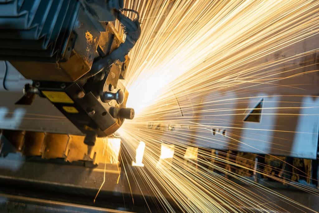 A manufacturing machine cutting material with lots of sparks