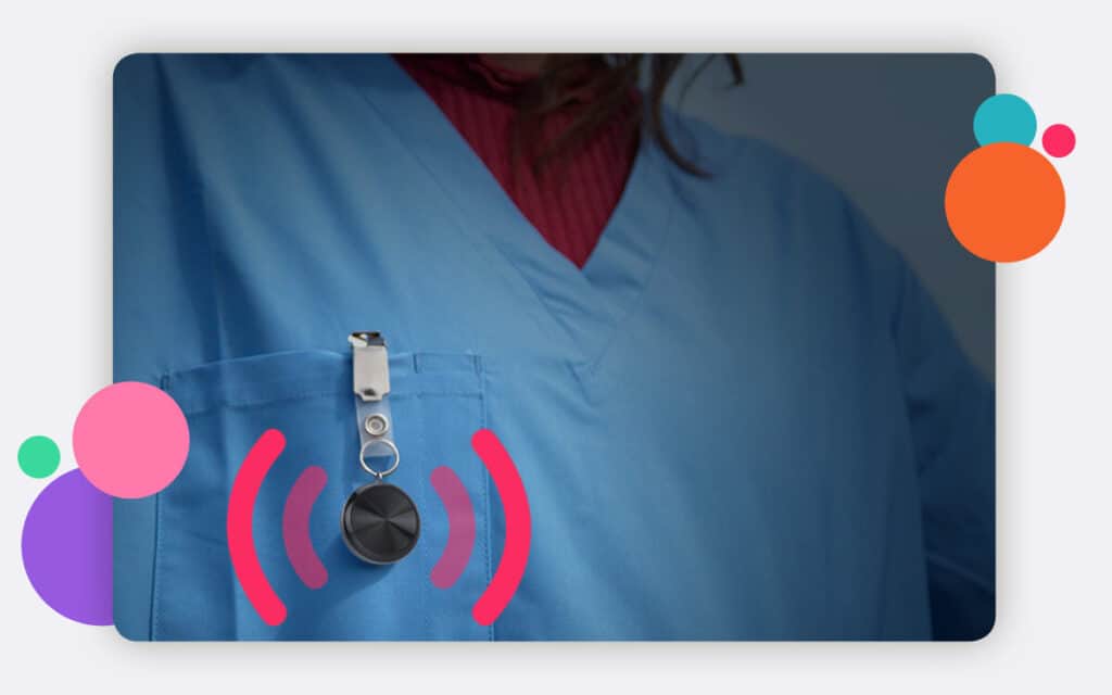 A safepoint wearable panic alarm clipped to the pocket of a nurse