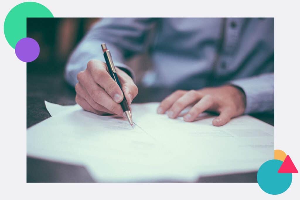 A person writing a policy on a piece of paper
