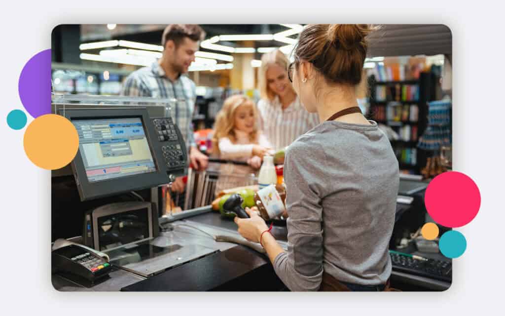 A supermarket till worker alone with customers scanning their shopping