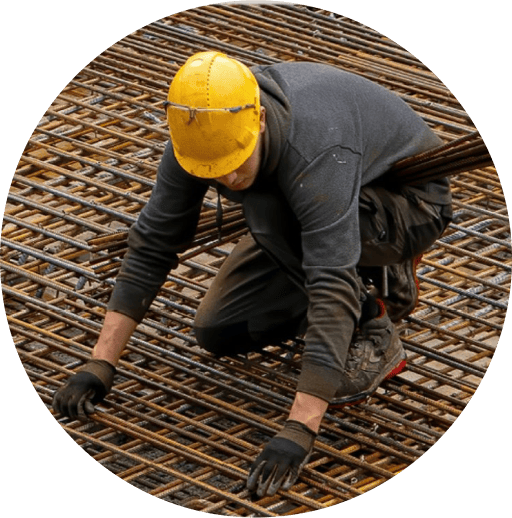 A construction worker tying rebar