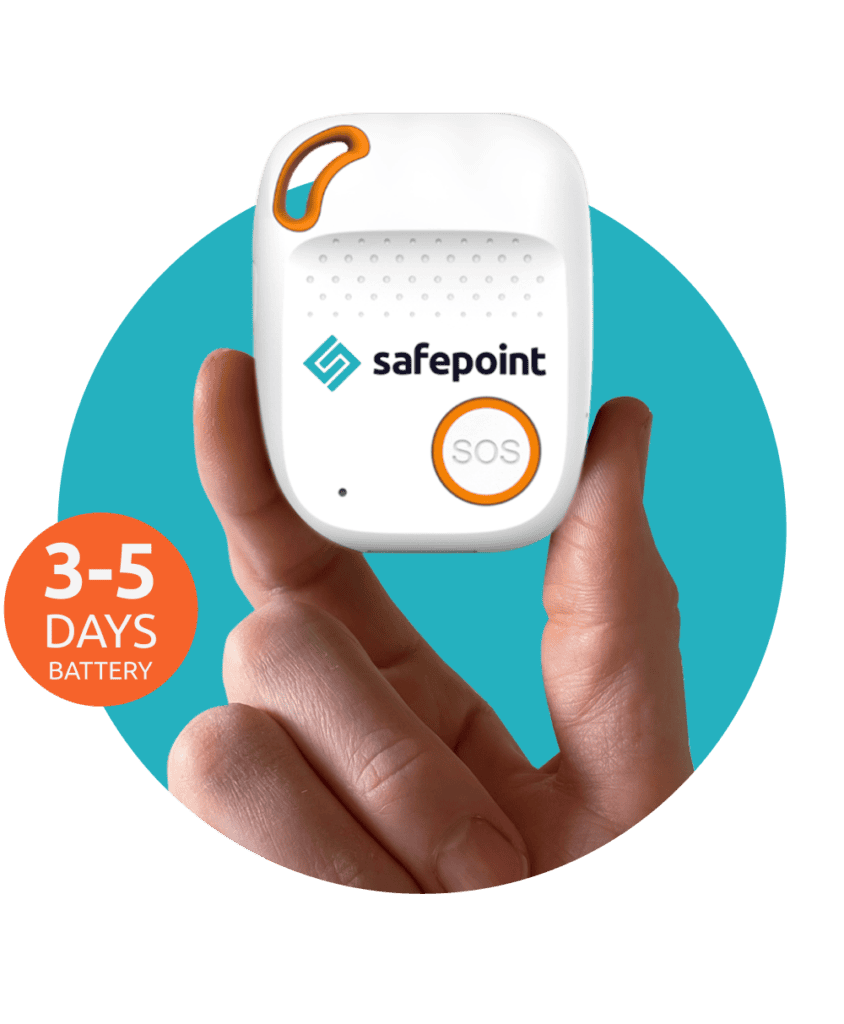 a hand holding a lone worker device